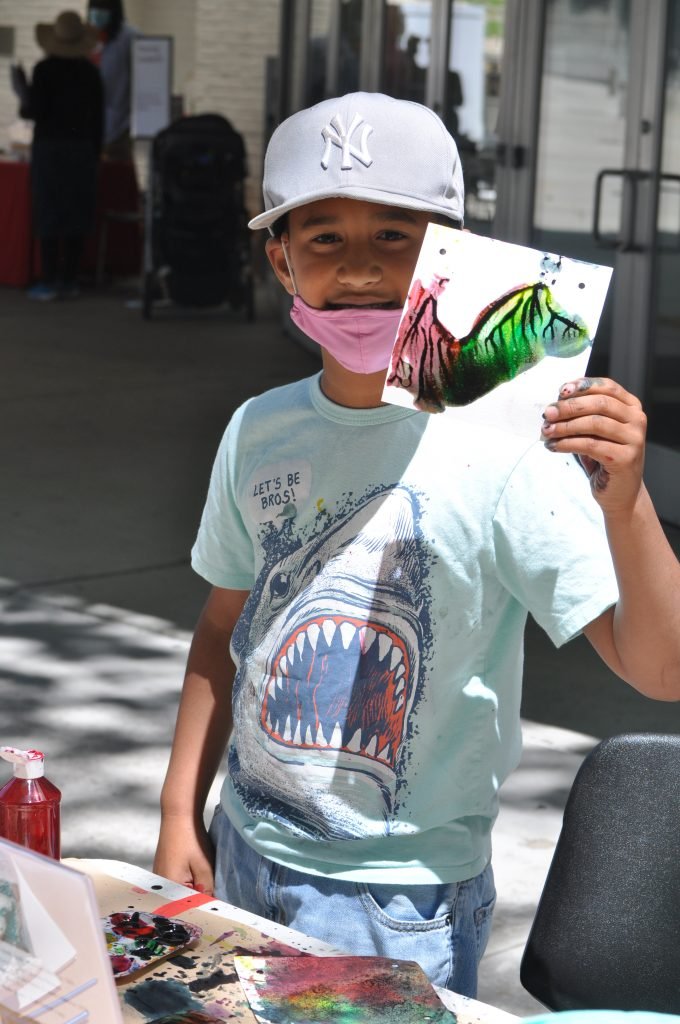 Bring the Cool! Honoring Juneteenth with Brooklyn Museum 2 A child holds up a painted square.
